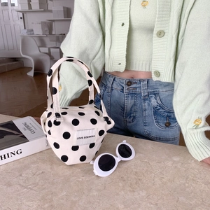 Close-up of cream canvas tote bag with black polka dots and LOVE SOZAKKA woven label