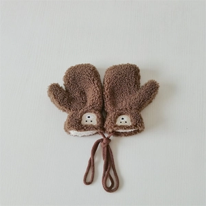 Detail of brown teddy fleece baby mittens with cute bear embroidery and neck string