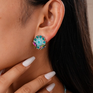 Close-up of vintage floral earrings with colorful crystals worn by a model