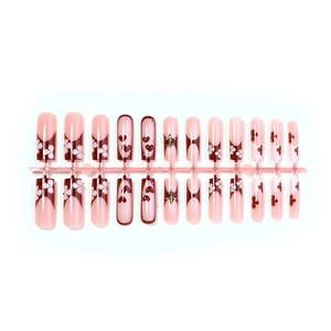 Pink and burgundy press-on nails with French tips and golden iris floral embossing