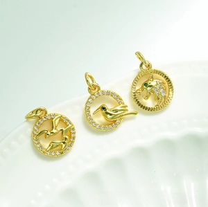 Detailed macro view of 18K gold plated animal pendants with micro-paved zircons