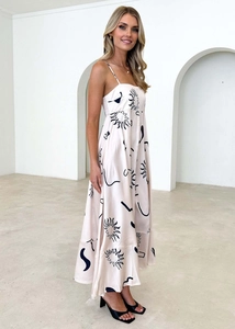 Detail of bohemian floral maxi dress featuring square neck and elegant sun print design