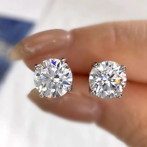 Macro shot of silver stud earrings featuring round-cut stones in classic four-prong setting