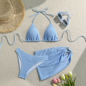 Detailed view of light blue crinkle fabric bikini set with matching mini beach sarong