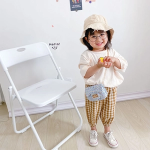 Mini blue tweed girl's shoulder bag with gold chain strap shown on a child model