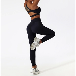 Detail view of high waist black yoga leggings with moisture-wicking compression fabric