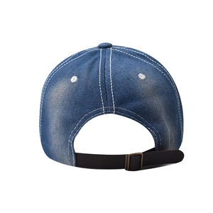 Detail view of the vintage washed denim baseball cap with adjustable leather back strap