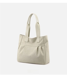 Detailed view of the pleated texture and premium thick canvas on this beige tote bag