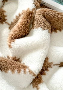 Detail of soft high-density animal print fleece blanket showing plush texture