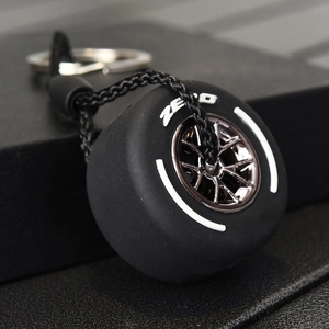 Racing tire keychain with black rubber wheel model and braided rope accessory