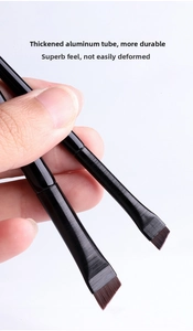 Detailed macro of angled eyeliner brushes with thickened brushed aluminum ferrules