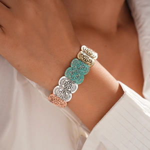 Close-up of vintage oval patterned bracelet with gold, silver and turquoise segments