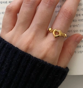 Detailed view of a gold hollow heart ring featuring a thick chain style band design