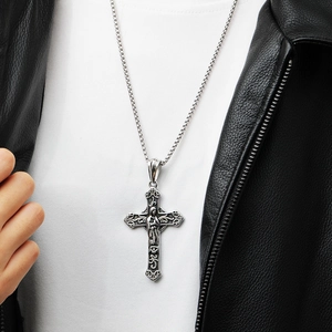 Silver vintage crucifix pendant necklace with Jesus figure worn by a male model