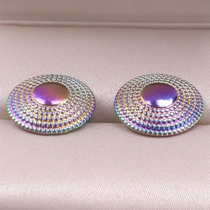 Macro shot of 304 stainless steel stud earrings with iridescent finish and beaded edge