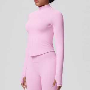 Detailed close-up of pink zip-up yoga jacket featuring ribbed texture and thumbhole cuffs