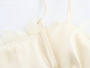 Detail of adjustable thin straps and petal edge on cream floral crop top camisole