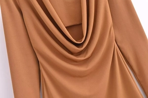 Close-up of the elegant cowl neck design and soft brown fabric on this long sleeve dress