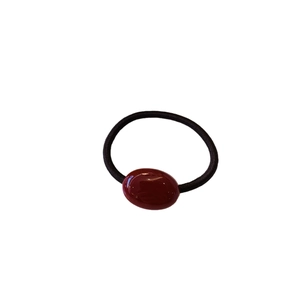 Elegant hair tie with black elastic band and polished dark red oval resin bead