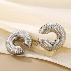 Polished silver stainless steel textured C-shape hoop earrings on a stone base