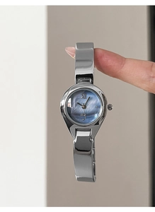 Detail of silver quartz watch with gradient blue dial and elegant metal bracelet