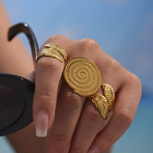 Retro gold leaf texture open ring with sunburst disc design on hand with sunglasses