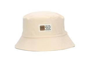 Detail of beige cotton bucket hat showing reinforced stitching and square logo patch