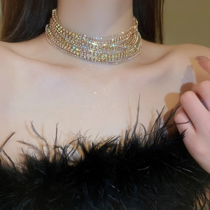 Close-up of luxury multi-layer gold choker necklace with sparkling rhinestones on neck