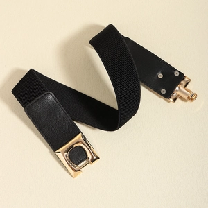 Detail of black elastic belt with leather trim and gold D-ring metal buckle for women