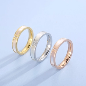 CNC shell inlay ring in gold, silver, and rose gold with three diamonds on blue background