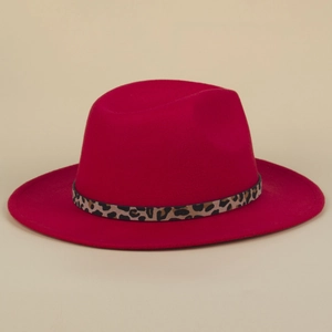 Close-up of red wool fedora hat featuring leopard print belt buckle and flat wide brim