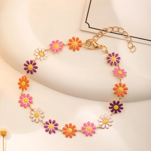Detailed close-up of colorful daisy charm bracelet with lobster clasp and extension chain