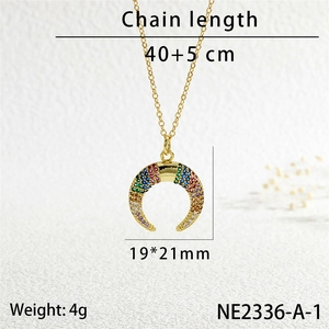 Detail shot of gold horn pendant with multi-color zircon stones and size specifications