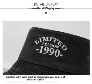Detail of washed cotton bucket hat featuring embroidered text and a reinforced sun visor