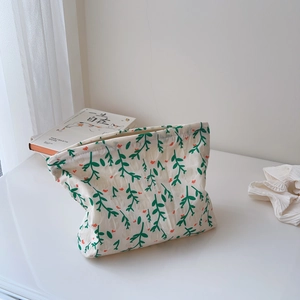 Detailed view of floral cotton toiletry bag with zipper and natural leaf pattern