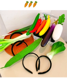Detail of realistic artificial vegetable headbands and hair clips on a wooden tray