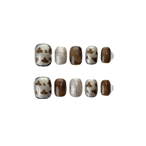 Handmade brown cat-eye press-on nails set with animal patterns and silver glitter accents