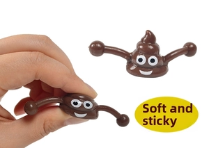 Detail showing hand squeezing soft sticky cartoon poop fidget toy on white background