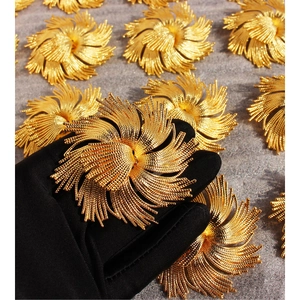 Golden woven flower brooch and earring set with intricate metallic textures for women