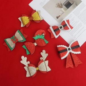 Close-up of glittery Christmas hair clips featuring reindeer antlers and holiday patterns