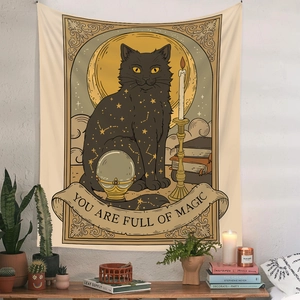 Detail of bohemian black cat tapestry featuring moon and star elements on a white wall