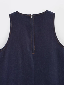 Detail of dark blue denim dress showing back zipper closure and orange contrast stitching