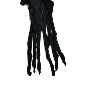 Close-up of the intricate black mesh fabric and ruffled strap details of the mini dress