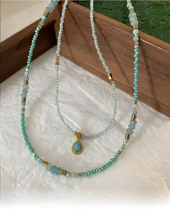 Detail of vintage beaded necklace with light green amazonite beads and drop pendant
