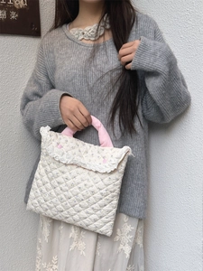 Detail of floral quilted laptop bag with lace trim and pink handle for women