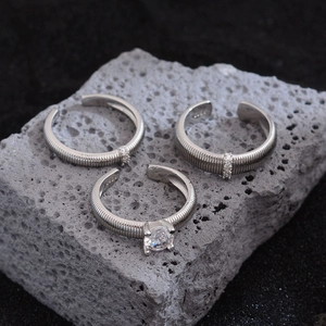 S925 sterling silver open rings with zircons on volcanic stone background