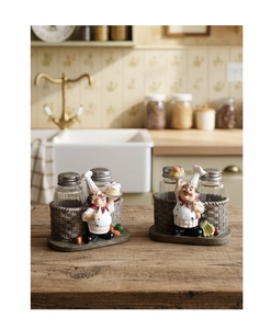 Close-up of resin chef statues with glass spice jars on a rustic woven basket base