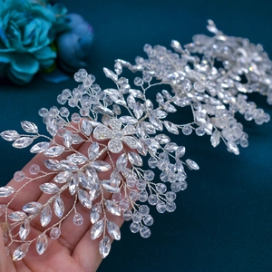 Close-up of handmade silver bridal headband featuring intricate crystal flowers and leaves