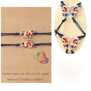 Detail of adjustable woven friendship bracelets with colorful butterfly charms