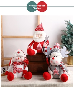 Close-up of knit Christmas plush dolls with Santa, Snowman and Reindeer sitting in cozy scene